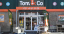 Delhaize sells Tom & Co.